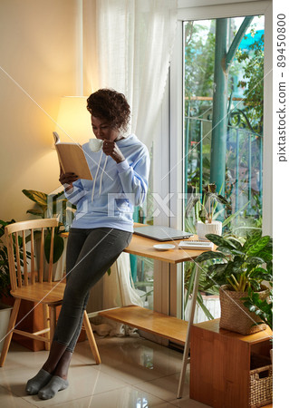 Woman Reading Captivating Book Woman Reading Captivating Book 89450800