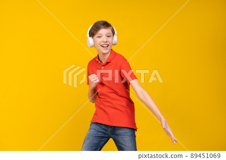 Portrait funny handsome caucasian guy in red t-shirt, listening to music Portrait funny handsome caucasian guy in red t-shirt, listening to music 89451069