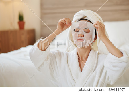 Woman Taking off Sheet Mask Woman Taking off Sheet Mask 89451071