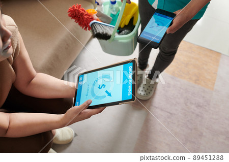 Woman Paying for Cleaning Service 89451288
