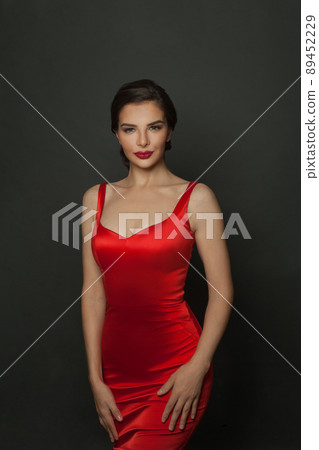 Perfect stylish model woman in red silky dress on black Perfect stylish model woman in red silky dress on black 89452229
