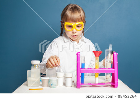Smart student child girl with flasks in school laboratory Smart student child girl with flasks in school laboratory 89452264