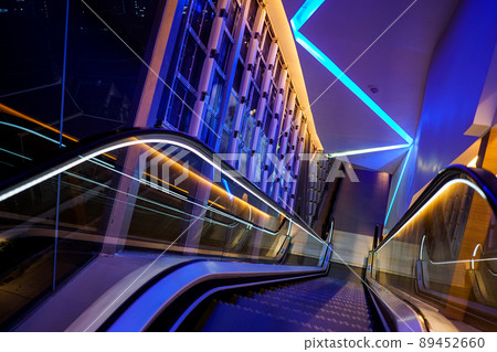 escalator with LED light beside in technology abstract neon colorful light theme. 89452660