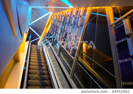 escalator with LED light beside in technology abstract neon colorful light theme. 89452661