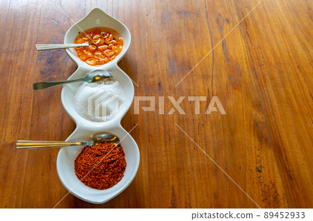 Asia flavoring in the liitle white bowl such as vinegar sugar and chilli fot a kind of noodle Thai style. Asia flavoring in the liitle white bowl such as vinegar sugar and chilli fot a kind of noodle Thai style. 89452933