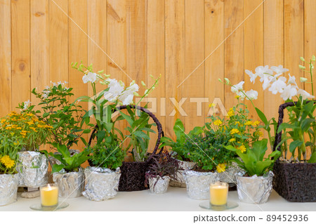 flowers decorate on the dinning long table in the luxury relax event with the wood plate background. 89452936