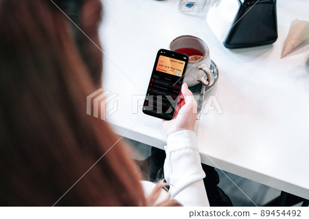 Internet based banking. Girl holding mobile phone with internet online bank app. Credit card wallet application. Online wallet save money. 89454492