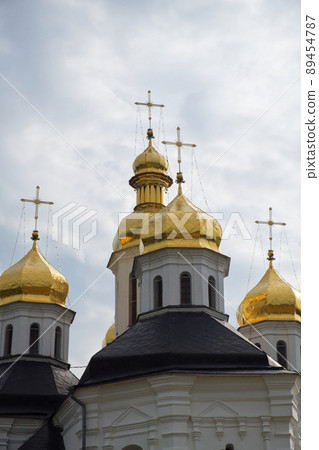 Gilded domes of an ancient Orthodox church against the sky. Catherine's Church is a functioning church in Chernihiv, Ukraine. St. Catherine's Church was built in the Baroque style. 89454787