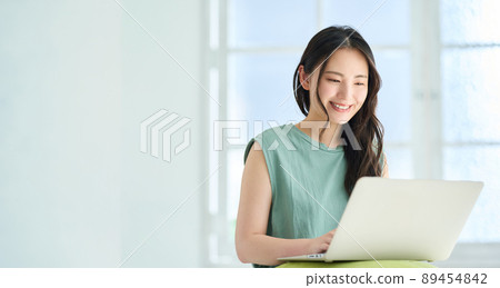 A young woman doing research on a laptop 89454842