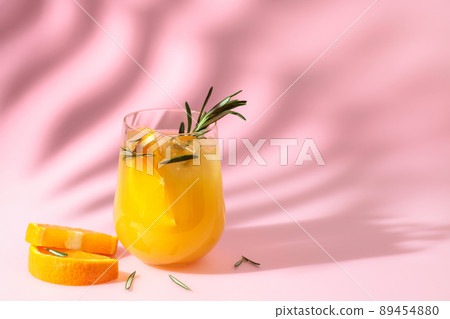 Summer cocktail with orange, rosemary, and ice. 89454880