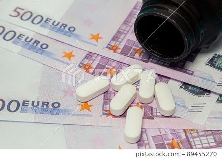 Money pills. Medicine pills on euro bills white medicine tablets on money. Covid-19 coronavirus Money pills. Medicine pills on euro bills white medicine tablets on money. Covid-19 coronavirus 89455270