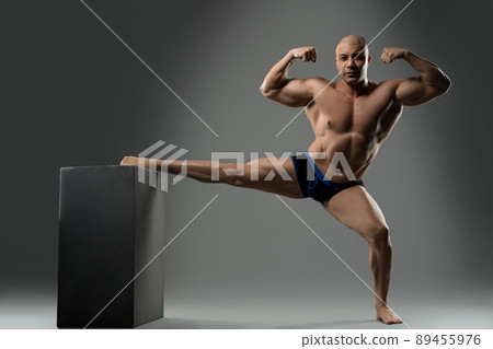Fit man in underpants show stretching and biceps Fit man in underpants show stretching and biceps 89455976