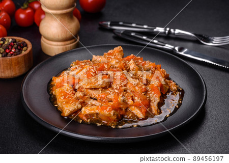 Teriyaki chicken with sauce, sesame, herbs and spices on a dark background 89456197