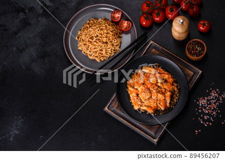 Thai noodle and chicken plate on a black concrete background with Chinese chopsticks and copy space Thai noodle and chicken plate on a black concrete background with Chinese chopsticks and copy space 89456207