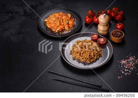 Thai noodle and chicken plate on a black concrete background with Chinese chopsticks and copy space 89456208