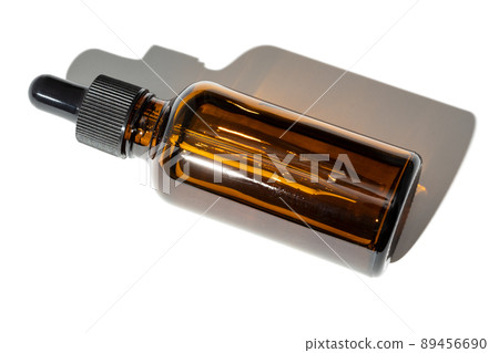 Essential oil amber bottle with pipette isolated on white background 89456690
