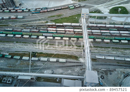 Aerial view of cargo train cars loaded with construction goods at mining factory. Railway transportation of industrial production raw materials Aerial view of cargo train cars loaded with construction goods at mining factory. Railway transportation of industrial production raw materials 89457521
