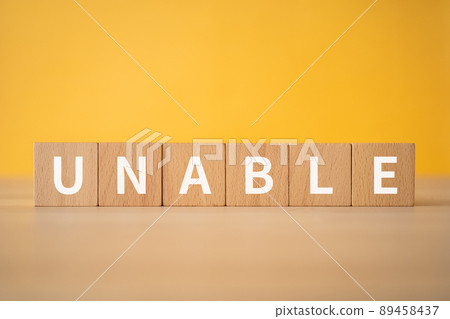 Building blocks with "UNABLE" written on them 89458437