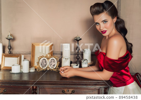 Pretty coquettish pin-up girl in retro interior 89458438