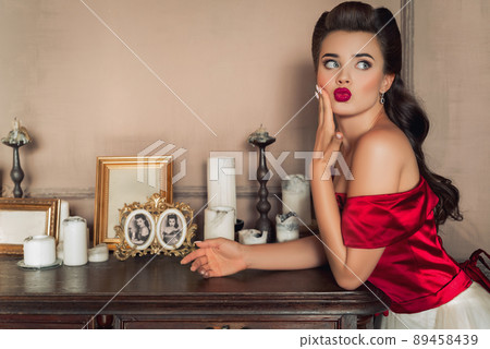 Pretty coquettish pin-up girl in retro interior 89458439