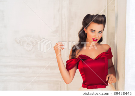 Pretty coquettish pin-up girl in retro interior Pretty coquettish pin-up girl in retro interior 89458445