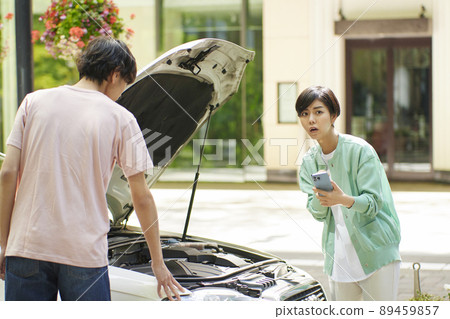 Young woman calling due to car breakdown 89459857