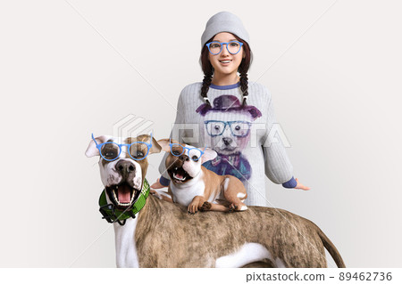 Two dogs and a girl wear the same blue glasses and pose happily Two dogs and a girl wear the same blue glasses and pose happily 89462736