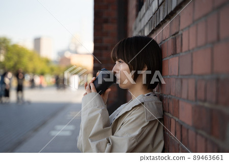 A pensive woman with a drink in her hand 89463661