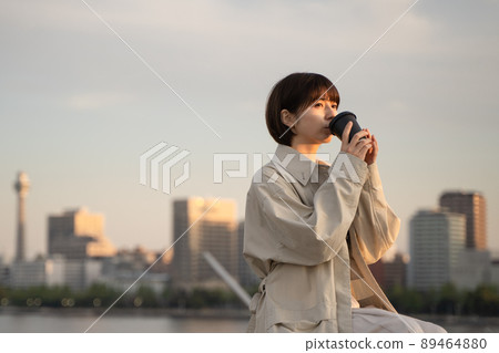 A woman relaxing on a bench 89464880