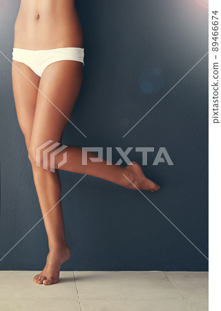 Beauty on tiptoes. Cropped shot of a woman's legs against a gray background. 89466674