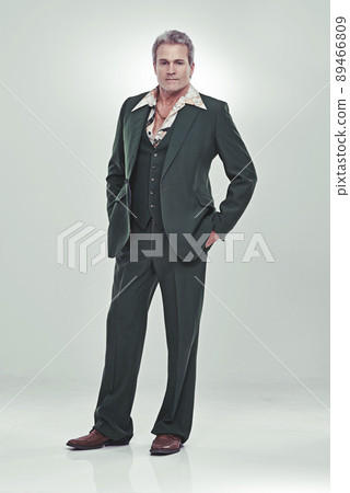 He's a show biz bigshot. Full length studio portrait of a mature man in a retro suit striking a confident pose. 89466809