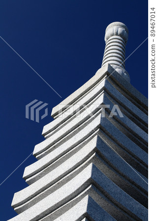A photo of a 13-tiered pagoda made of white stone with a blue sky in the background A photo of a 13-tiered pagoda made of white stone with a blue sky in the background 89467014