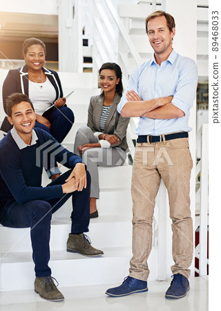 Teamwork is everything in business. Portrait of a group of coworkers in a stairwell in a modern office. 89468033