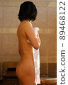 A woman entering a hot spring 89468122