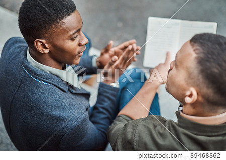 Constructing the perfect recipe for success. Shot of two young businessmen having an informal meeting against an urban background. 89468862