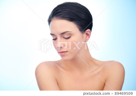 Flawless natural beauty. A gorgeous young woman looking at the cameraa. 89469509