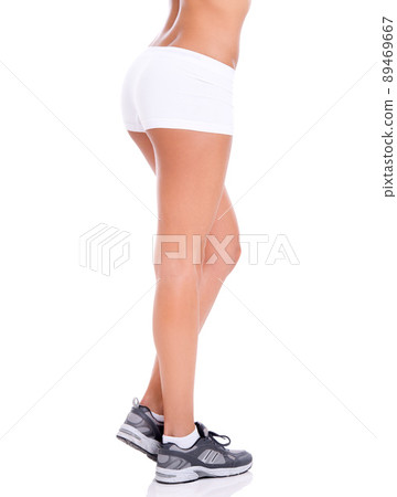 These took a lot of squats. Cropped studio shot of a fit woman's legs isolated on white. 89469667