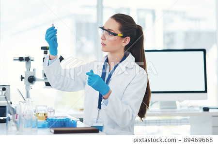 Here it is. Cropped shot of a focused young female scientist mixing chemicals together inside of a laboratory during the day. 89469668