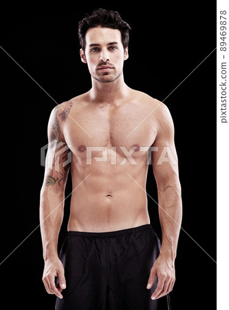 Handsome and brooding. Studio shot of a bare-chest and fit young man. Handsome and brooding. Studio shot of a bare-chest and fit young man. 89469878