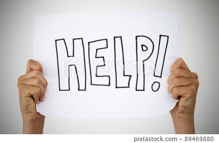 Asking for help is a sign of strength. Studio shot of an unrecognisable person holding up a sign that says help against a grey background. Asking for help is a sign of strength. Studio shot of an unrecognisable person holding up a sign that says help against a grey background. 89469880
