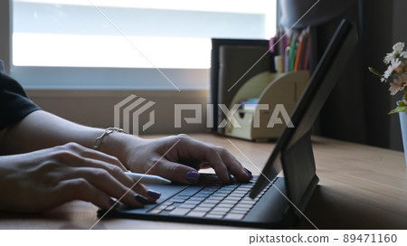 Man hands typing on wireless keyboard go digital tablet. Cropped shot. Man hands typing on wireless keyboard go digital tablet. Cropped shot. 89471160