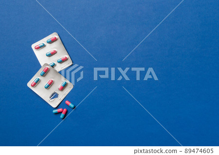 Protective face masks or surgical masks, medicine pills and thermometer on table background. Coronavirus disease. Corona virus concept. Space for text 89474605