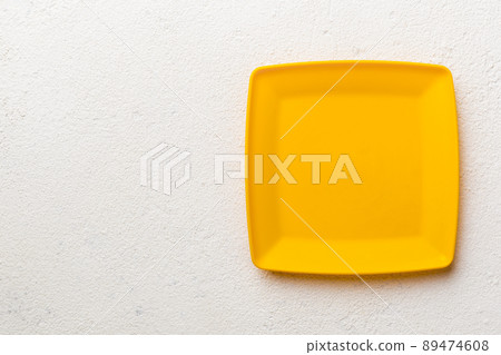Top view of empty square plate on cement background. Empty space for your design Top view of empty square plate on cement background. Empty space for your design 89474608