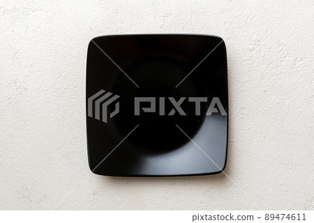 Top view of empty square plate on cement background. Empty space for your design Top view of empty square plate on cement background. Empty space for your design 89474611