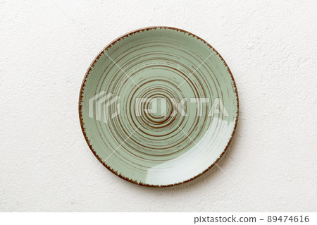 Top view of empty green plate on cement background. Empty space for your design 89474616