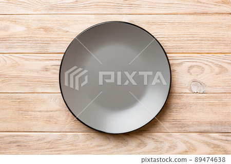 Top view of empty grey plate on wooden background. Empty space for your design 89474638