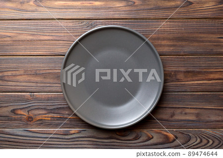 Top view of black plate on wooden background. Empty space for your design 89474644