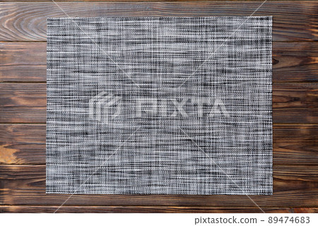 Top view of grey tablecloth for food on wooden background. Empty space for your design 89474683