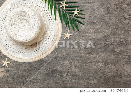 Summer holidays. Summer concept with straw hat and tropical leaf. Flat lay, top view, copy space 89474684