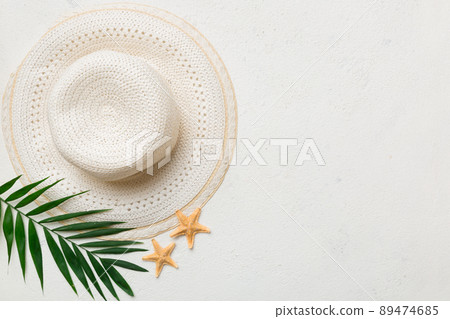 Summer holidays. Summer concept with straw hat and tropical leaf. Flat lay, top view, copy space 89474685